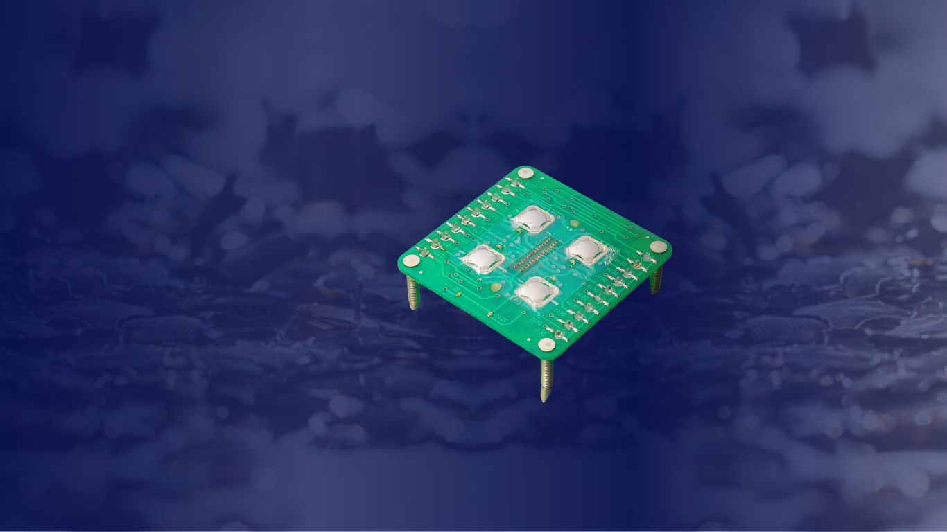 A printed circuit board with tactile metal domes arranged in a square.