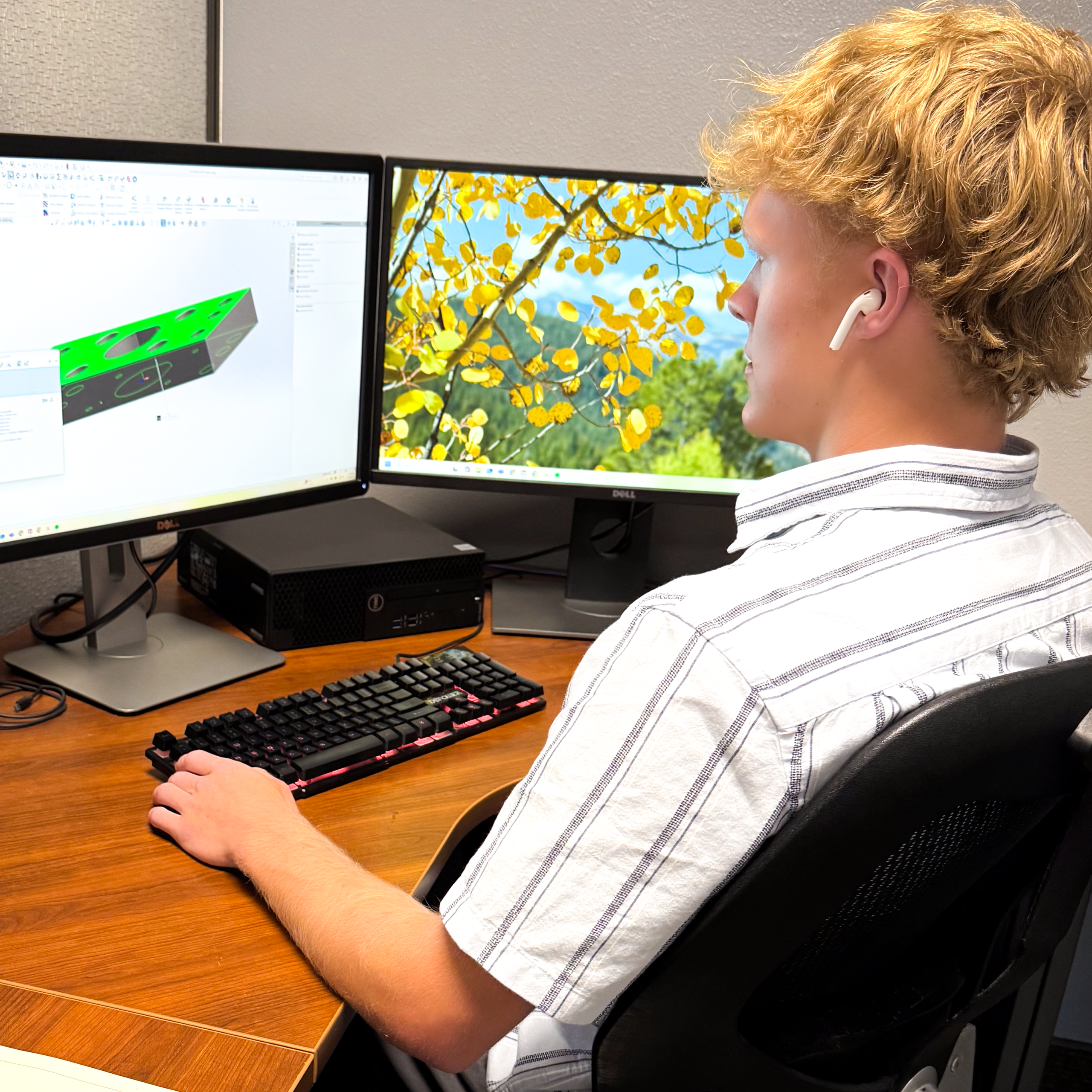 an engineer reviews some tooling for metal dome switch design